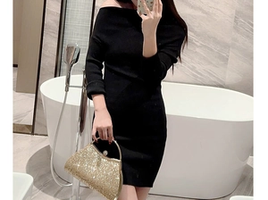 Detail of black off-the-shoulder knitted mini dress featuring a slim-fit waist design