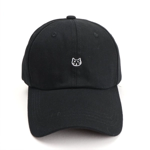 Classic black cotton baseball cap with cute white cat embroidery on a plain background