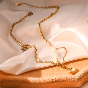 18K gold titanium steel necklace with heart pendant and pearls on champagne silk