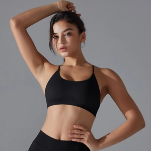 Close-up of black seamless knit yoga bra with cross back design and breathable texture