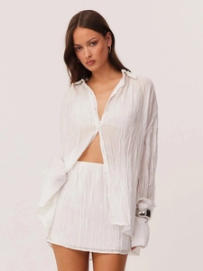 Two-piece white textured shirt and mini skirt set with vertical pleated fabric detail