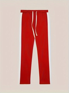 Detail of red sports joggers with white side stripes and adjustable drawstring waist