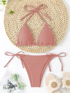 Pink ribbed triangle bikini set with halter top and side-tie bottoms for summer beach vacation