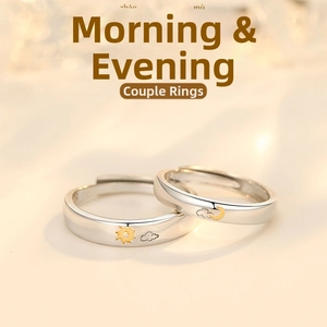 Detail of sun and moon relief on silver couple rings with adjustable open band design