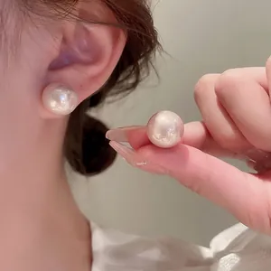 Elegant high-luster large white pearl stud earrings with minimalist silver needle design