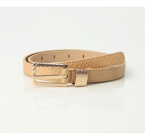 Detail of thin leather belt featuring pebble texture and wavy golden buckle