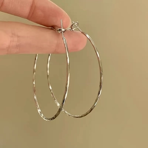 Silver textured large hoop earrings featuring an irregular hammered finish for women