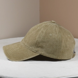 Close-up of washed cotton baseball cap featuring reinforced stitching and breathable eyelets