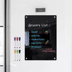 Close-up of black acrylic magnetic fridge board with grocery list and colored markers