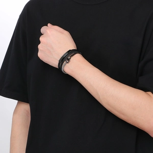 Close-up of black multilayer braided leather bracelet for men with metal magnetic clasp