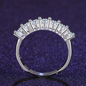 Close-up of sparkling seven-stone eternity ring with silver metal and round cut cubic zirconia
