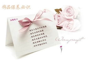 Care guide card for crystal bridal crowns featuring jewelry maintenance tips with pink ribbon