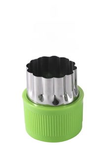 Detail of stainless steel vegetable cutter mold with green protective plastic handle