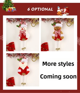 Detail of Christmas plush pendants featuring Santa and snowman with golden bells