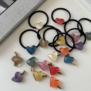 Detailed view of colorful heart-shaped resin hair clips and elastic hair ties set