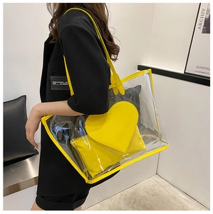 Detail of transparent PVC tote bag with yellow trim and inner heart pouch
