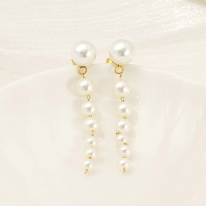 Elegant long pearl drop earrings with gradient white pearls and gold metal accents
