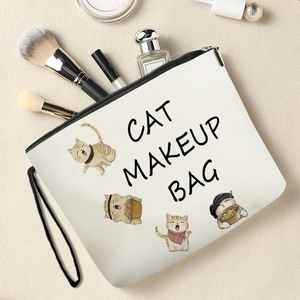 Canvas cat makeup bag with cute orange kittens and makeup accessories on the table
