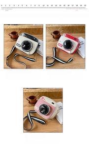 Three camera-style crossbody bags in black, red, and pink with striped straps