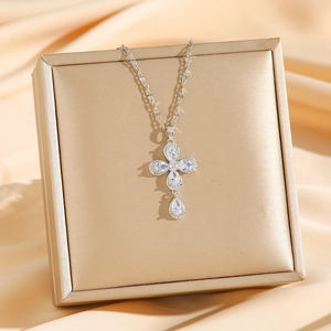Silver four-leaf clover pendant necklace with white zircons on elegant champagne satin
