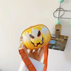 Detail of Jack-o'-lantern pumpkin crossbody bag with white melt design and gold hardware
