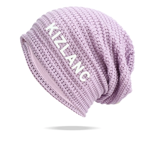 Close-up of purple breathable hollow knit texture and KIZLANC logo on the beanie hat