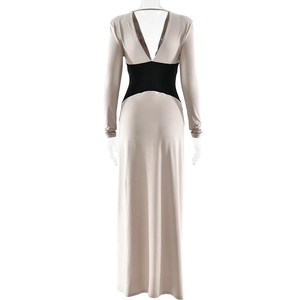 Rear view of sleek beige long-sleeve dress featuring a high-waist black contrast panel