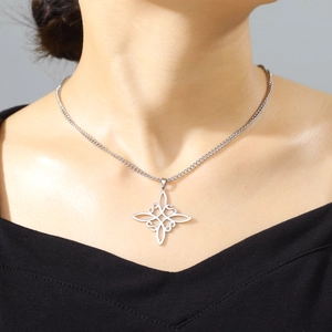 Elegant silver stainless steel Celtic Witch Knot pendant necklace worn by model