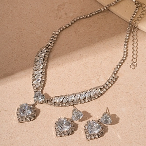Close-up of heart-shaped zircon jewelry set featuring a necklace and stud earrings