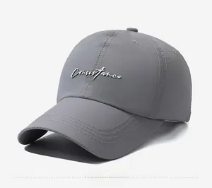 Close-up of dark grey quick-dry baseball cap with white embroidery and 45-degree side view