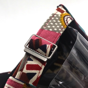 Detail of adjustable canvas back strap and vintage metal buckle on printed baseball cap