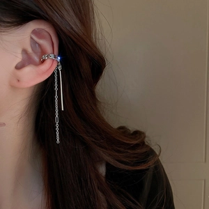 Close-up of silver tassel ear cuff with sparkling cubic zirconia on a female model