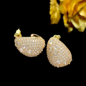 Close-up of gold water drop earrings with shimmering micro-pave zircon crystals