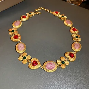 Vintage style gold necklace with red heart gems and pink cameo portrait charms