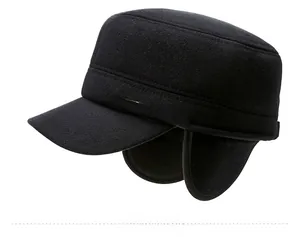 Macro detail of men winter flat cap featuring warm ear flaps and silver Sports logo side view