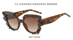 Close-up 45-degree angle of leopard print irregular cat eye sunglasses with gradient lenses
