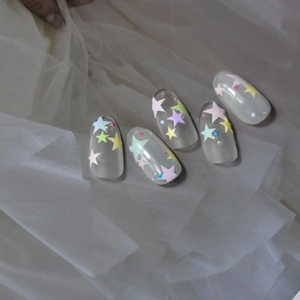 Detailed view of 5D embossed nail art stickers with colorful stars on soft white tulle