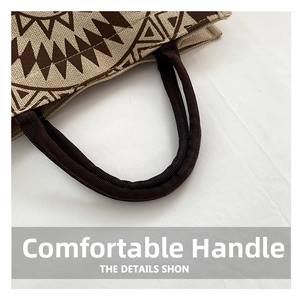 Close-up of thick woven brown handles on a patterned linen tote bag for durability