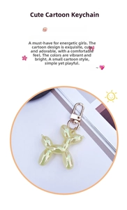 Detailed view of an iridescent yellow balloon dog keychain with a gold metal clasp