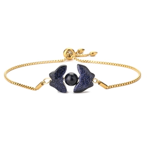 Detail of adjustable gold bracelet featuring blue sandstone butterfly wings and beads