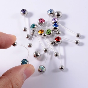 Macro shot of flexible acrylic belly ring showing high flexibility and colorful rhinestones