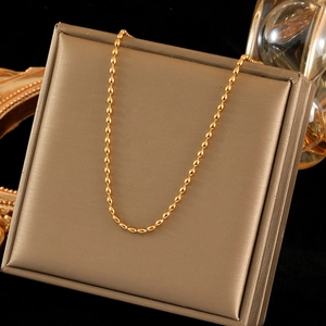 18K gold plated stainless steel bead chain necklace displayed on a luxury stand