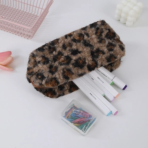 Flat lay of a leopard print plush pencil case with markers on a white desk