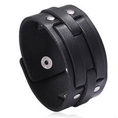 Close-up of black leather wide bracelet featuring braided bands and metallic rivets detail