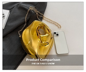 Irregular gold acrylic clutch bag size comparison next to a smartphone on a grey blazer