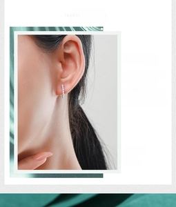 Close-up of elegant S925 silver pearl stud earrings worn on ear with minimalist style