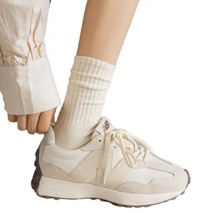 Baskets rétro blanc cassé avec chaussettes côtelées sur fond blanc