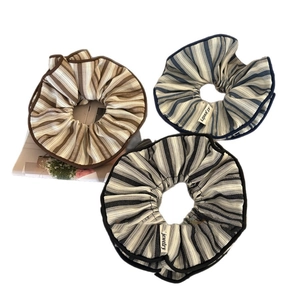 Three-piece set of striped fabric scrunchies in coffee, blue, and black colors