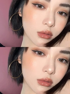 Close-up of oversized thin gold titanium steel hoop earrings on model for a trendy look