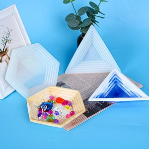 Detail view of hexagonal and triangular silicone molds for DIY resin craft tray making